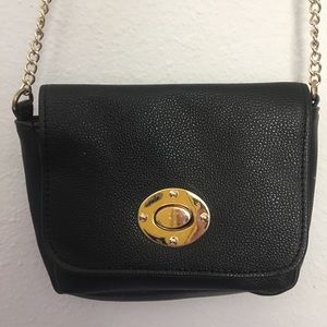 Black purse golden accents and chain